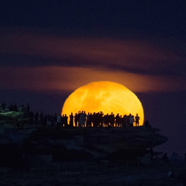 The moon rises above Ben Buckler point at Bondi, Sydney, a day after the official supermoon which was obscured by clouds. Photo: Janie Barrett / Fairfaxmedia